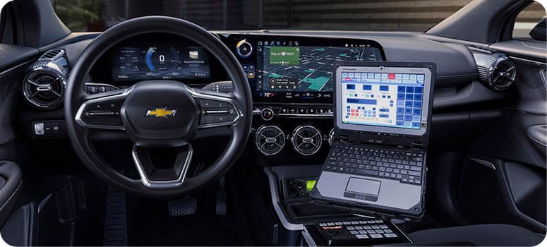 Front-seat view of 2024 Chevrolet Blazer EV PPV interior in black with Havis console and laptop. Preproduction model shown. Actual production model may vary. 2024 Chevrolet Blazer EV PPV available first quarter of 2024.