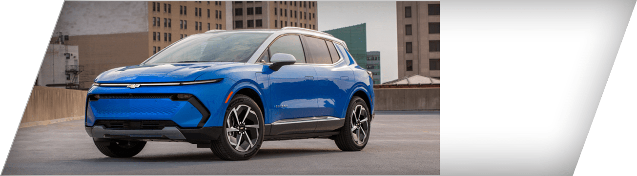 Front 3/4 view of a 2025 Chevrolet Equinox EV LT in Riptide Blue Metallic with a Summit White roof parked on the roof of a parking garage.