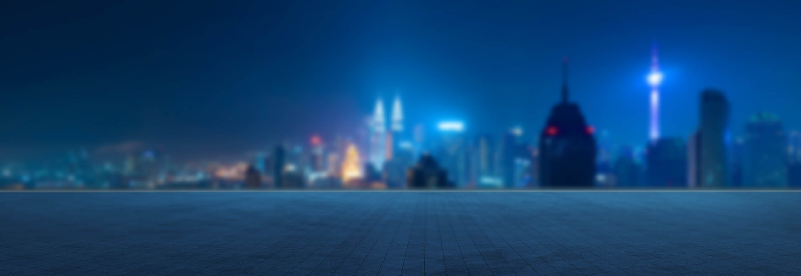 Panoramic view of empty concrete tiles floor with city skyline. Night scene.
