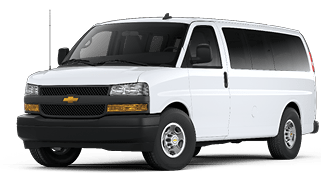 A white passenger van with tinted windows and a black front bumper is shown on a white background. Description generated by AI