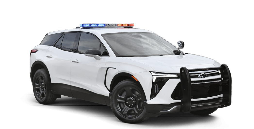 A white SUV with a police car on top. Description generated by AI